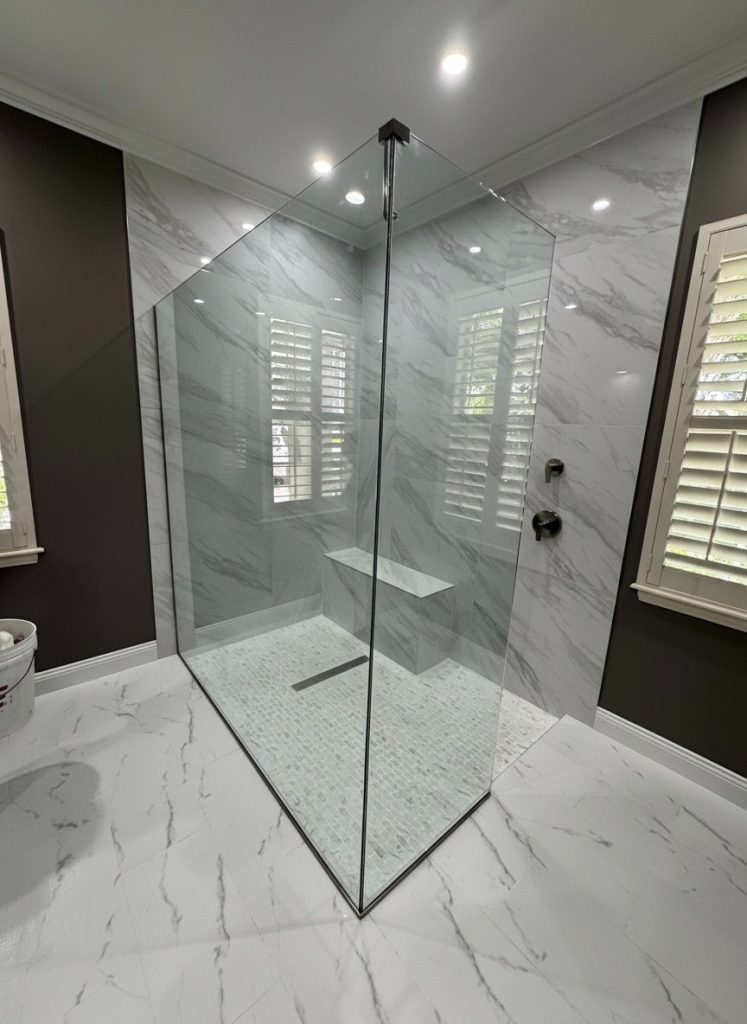 Frameless corner glass shower enclosure installed by Florida Glass Company in Southwest Florida